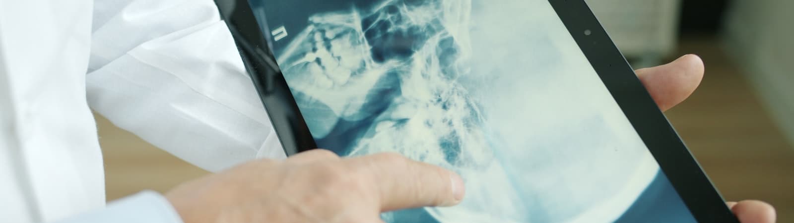 Medical professional analyzing diagnostic imaging on tablet